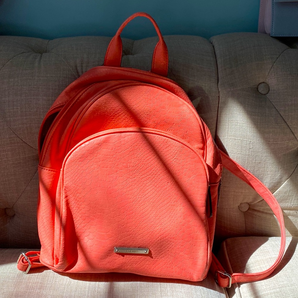 Coral pink Nine West backpack.